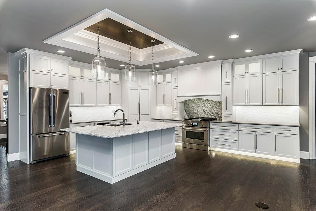 Finished white kitchen with marble island and pendant lights, Quad Cities