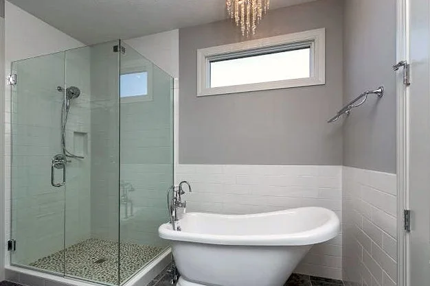 Finished primary bath with a freestanding slipper tub and glass walk-in shower, Quad Cities
