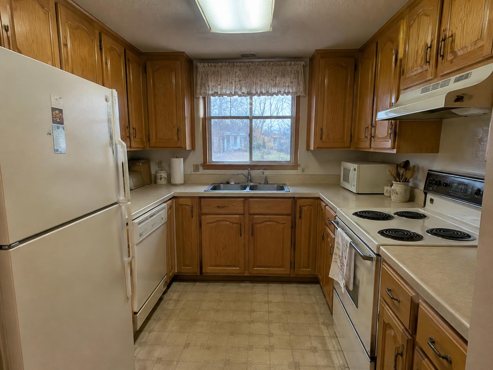 Finished white kitchen with island, Quad Cities, before